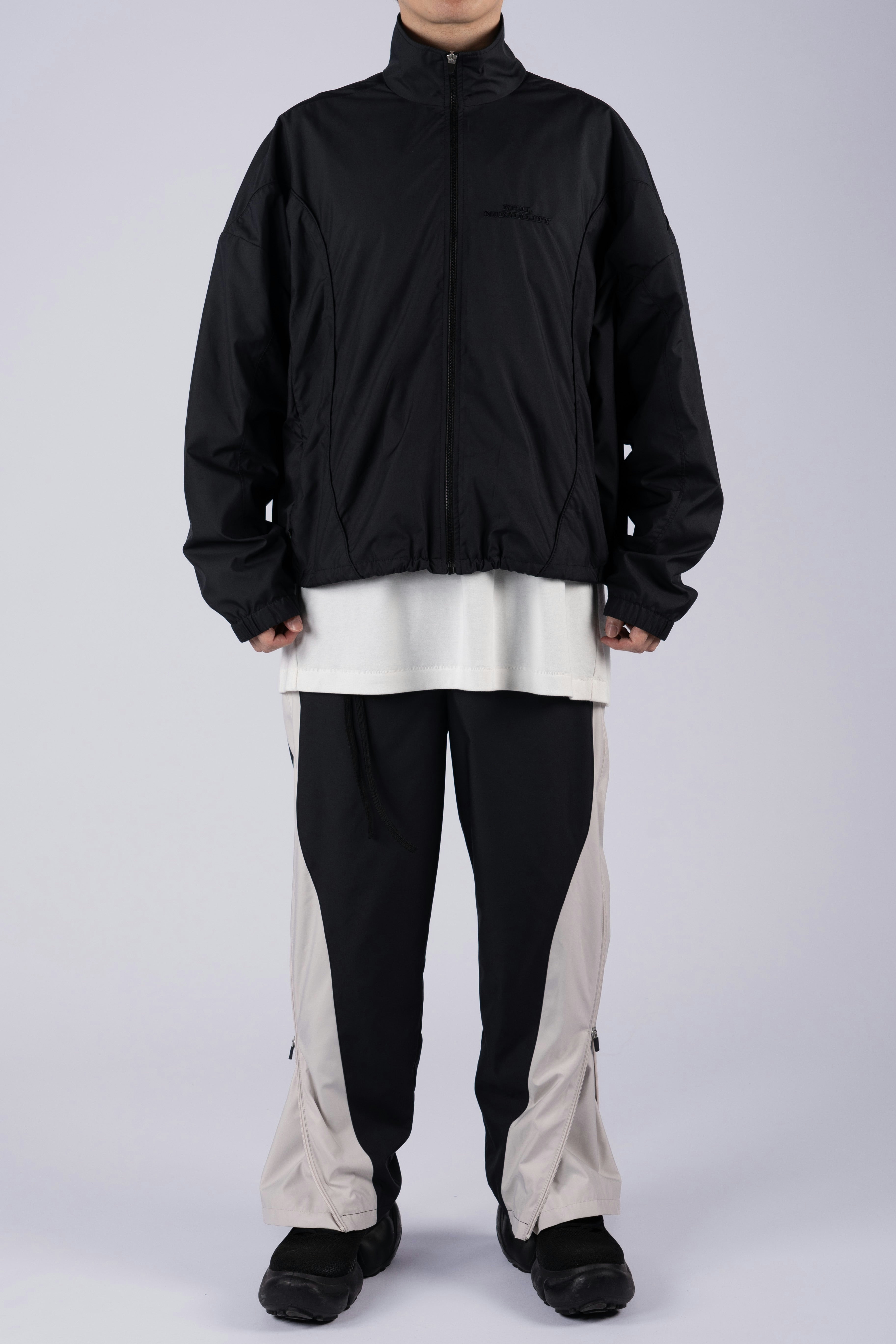 “REAL NORMALITY” Panelled Track Jacket - Black/Black