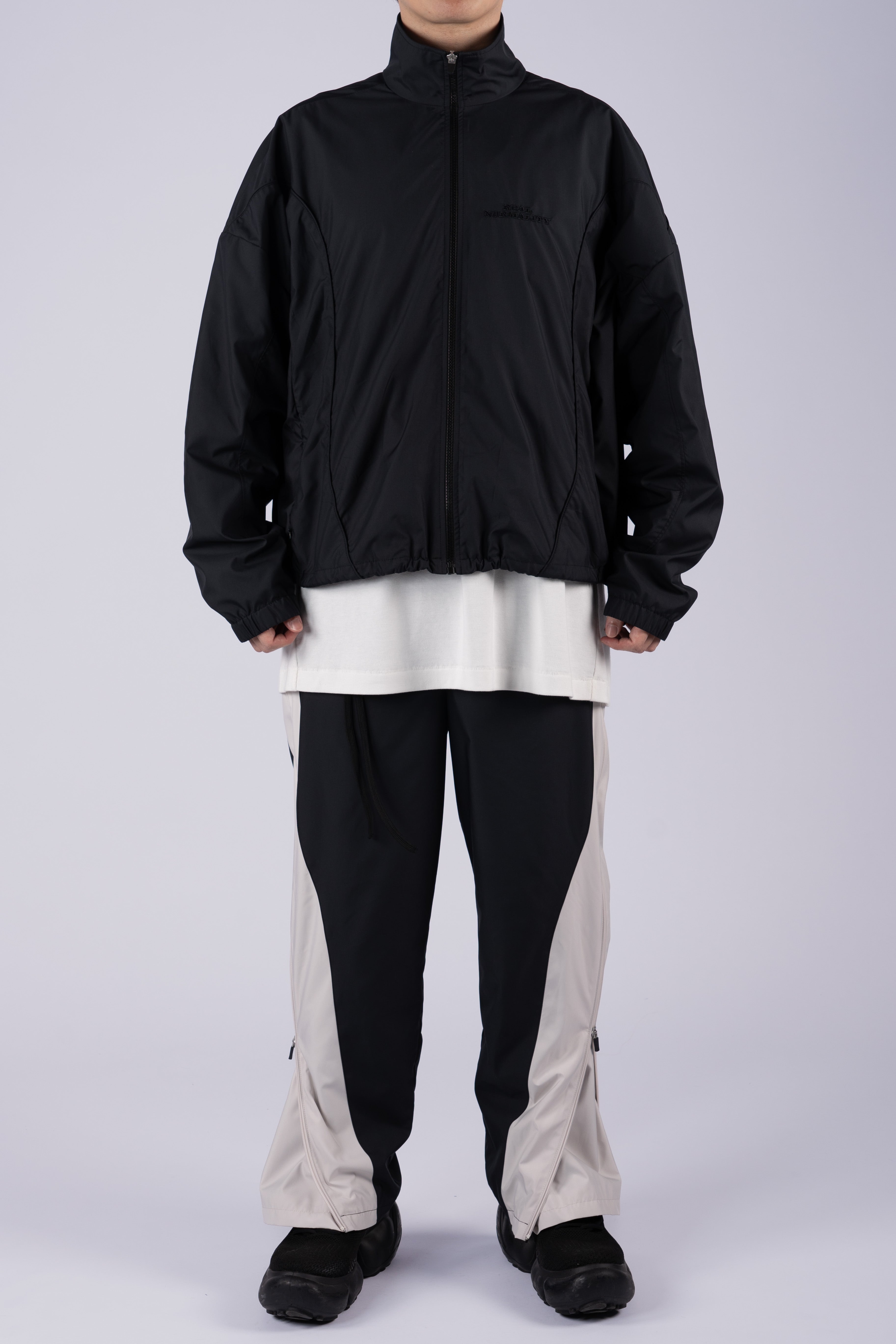 “REAL NORMALITY” Panelled Track Jacket - Black/Black