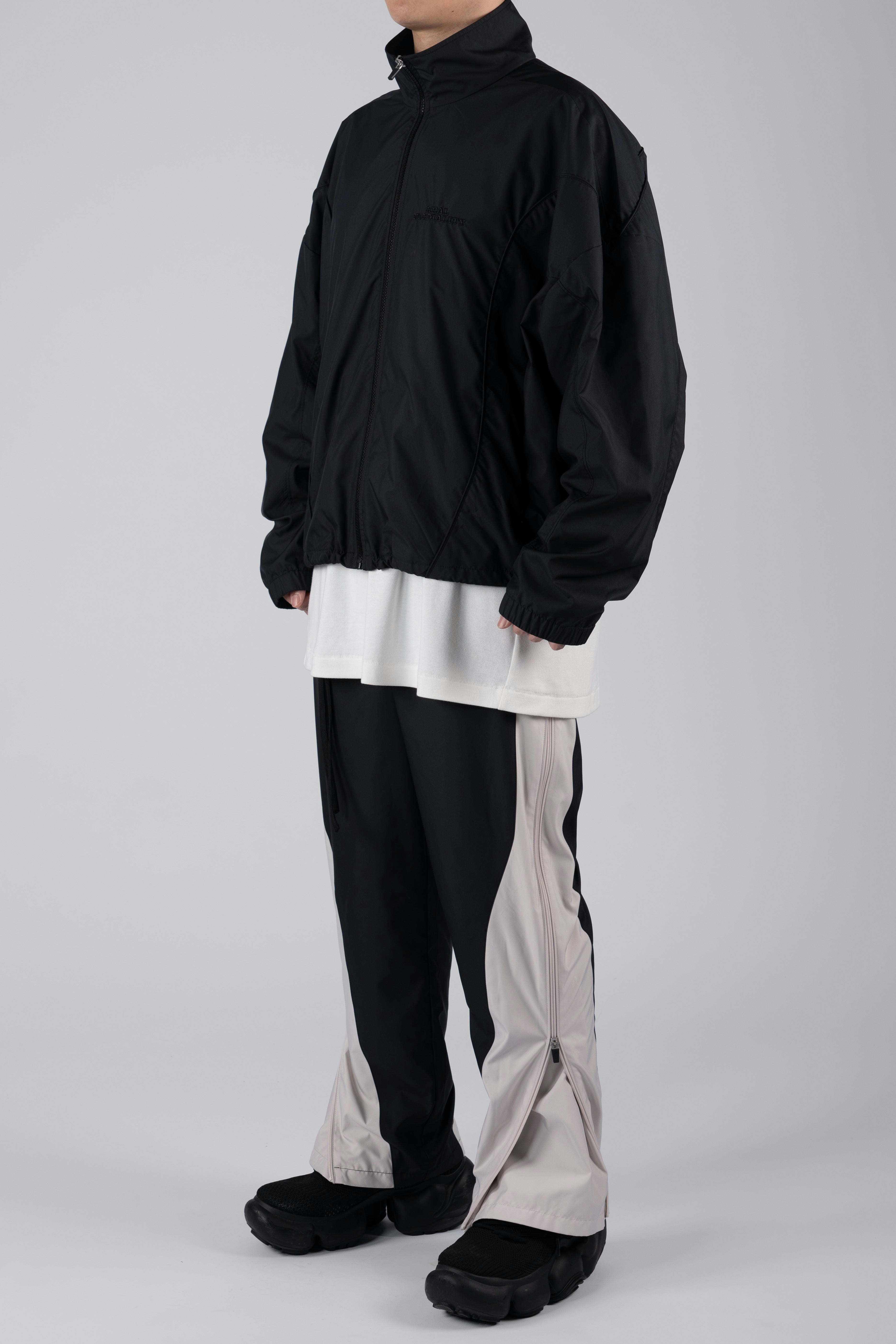 “REAL NORMALITY” Panelled Track Jacket - Black/Black