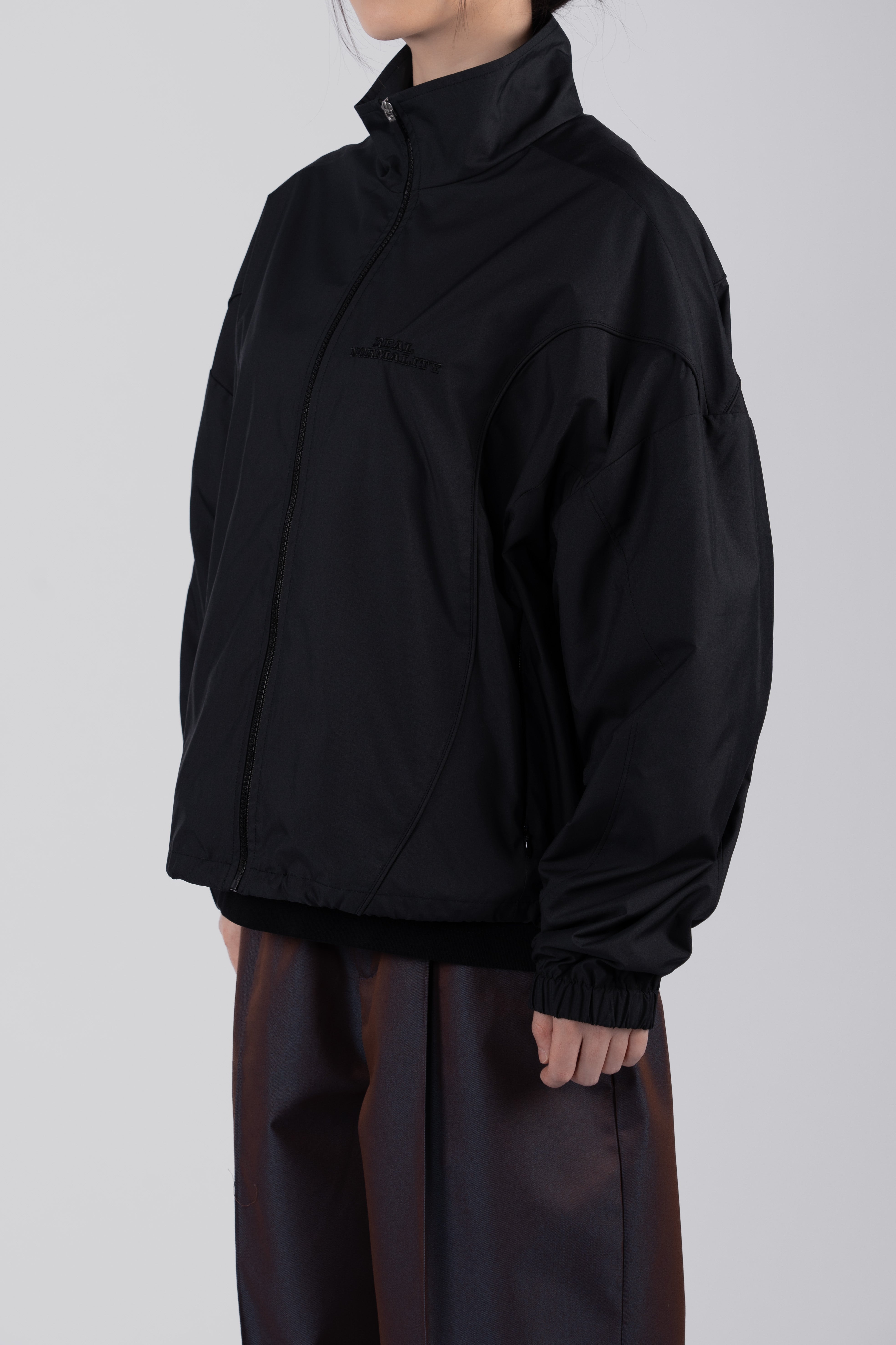 “REAL NORMALITY” Panelled Track Jacket - Black/Black