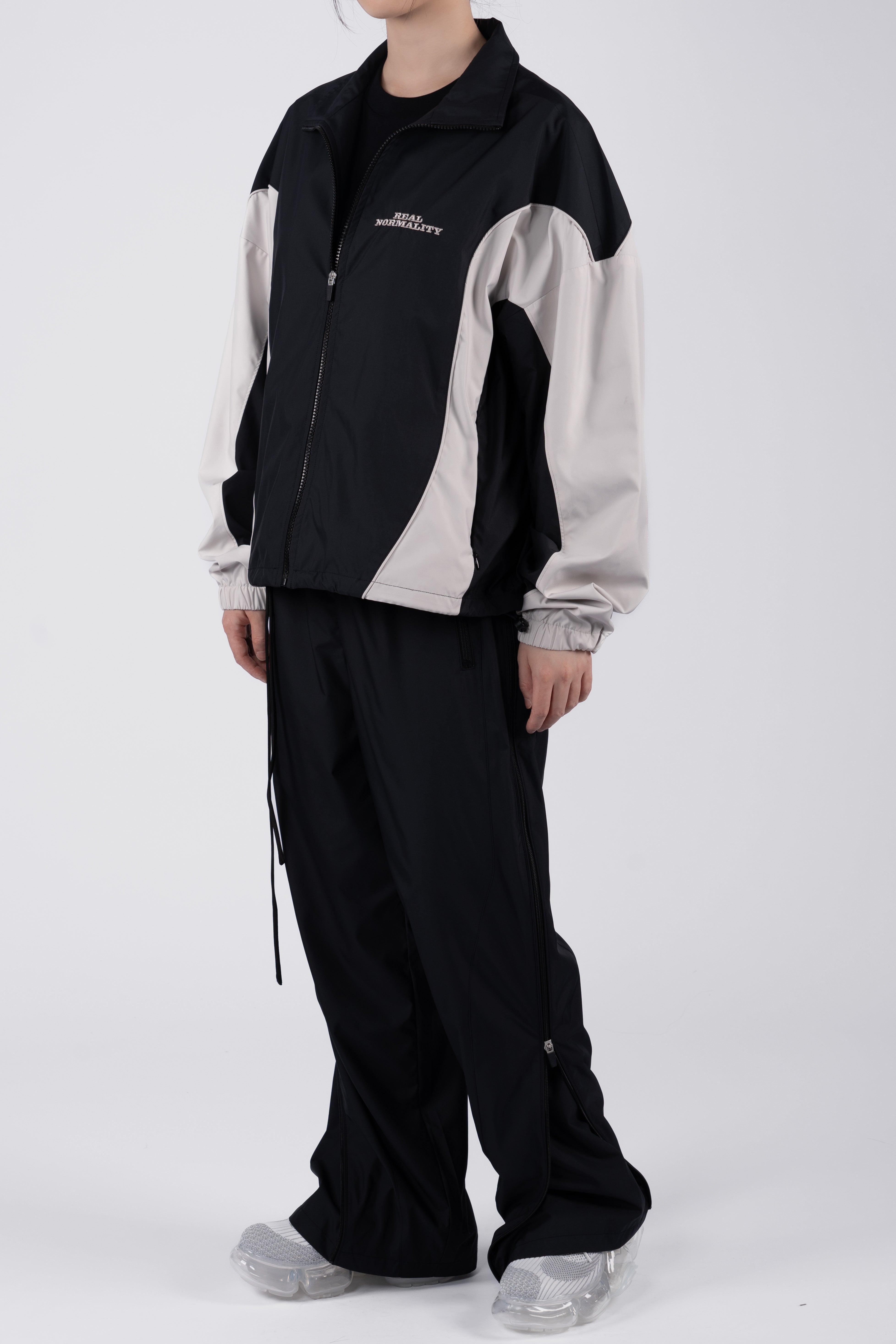 “REAL NORMALITY” Panelled Track Jacket - Black/Off White