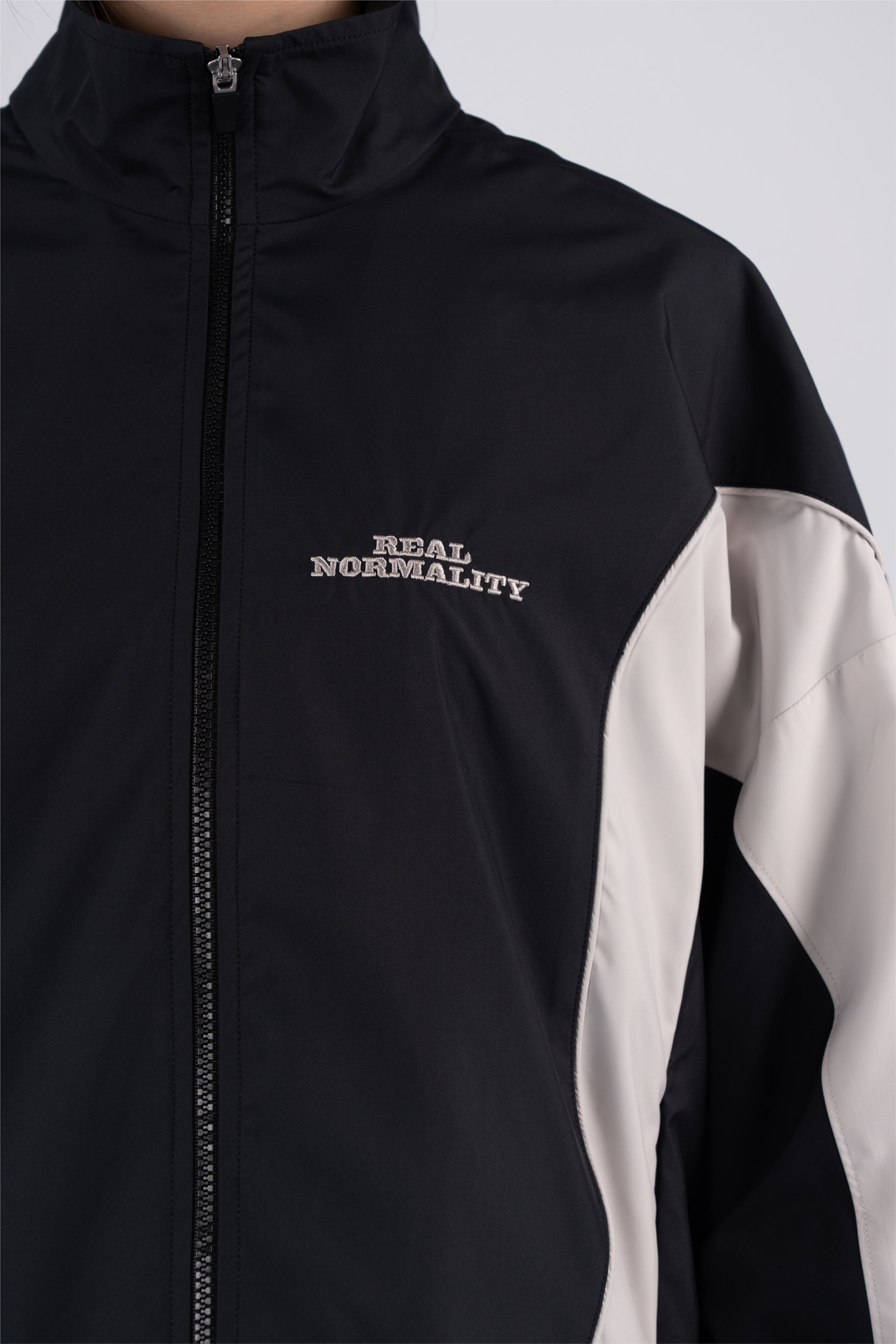 “REAL NORMALITY” Panelled Track Jacket - Black/Off White