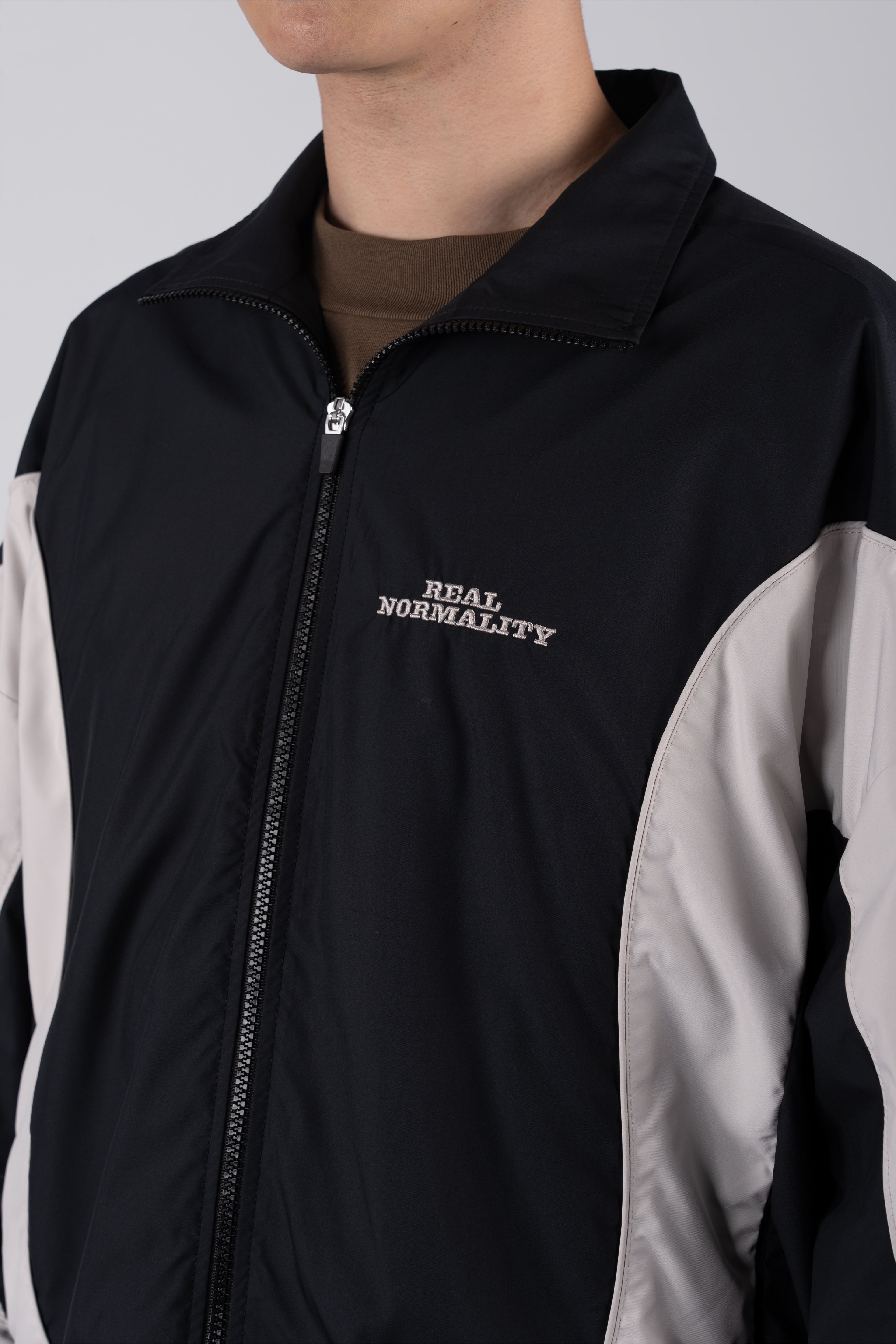 “REAL NORMALITY” Panelled Track Jacket - Black/Off White