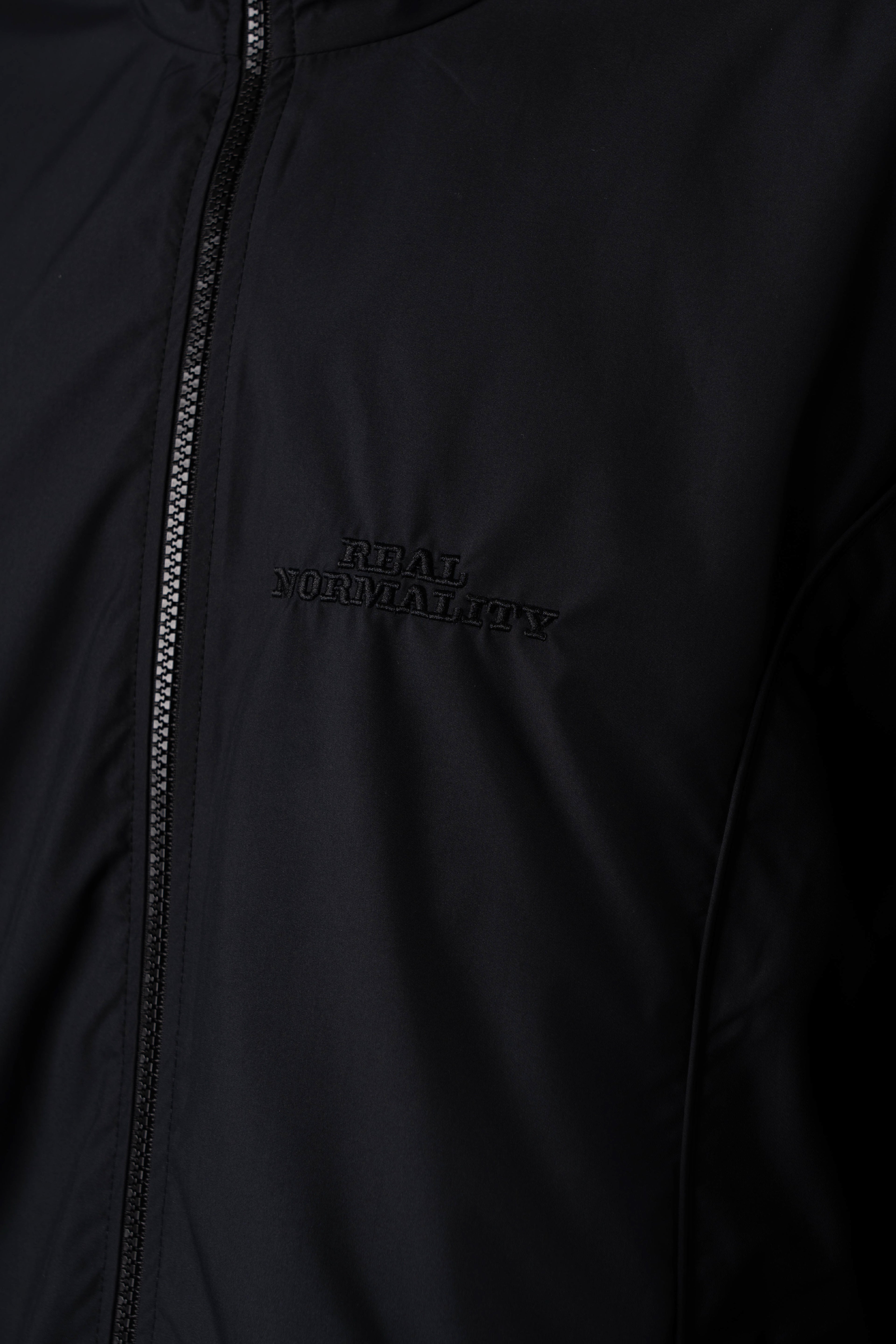 “REAL NORMALITY” Panelled Track Jacket - Black/Black